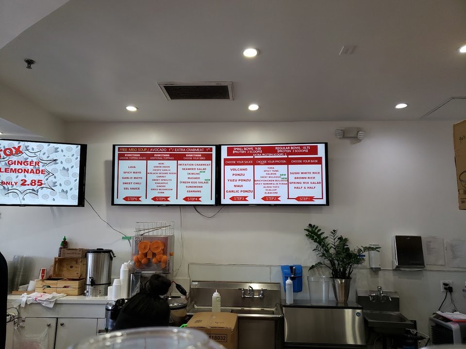 Casual restaurant seating beside a prepared bowl display